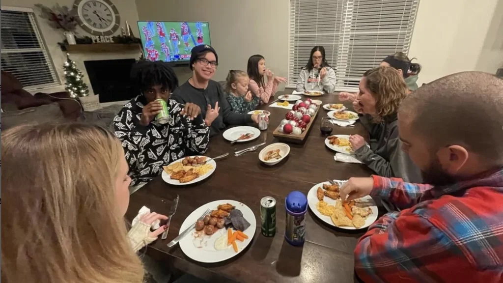 The NW Brooklyn Park small group sharing dinner around the table at a host home