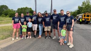 Clarity Church serve team in matching navy shirts gathered outdoors