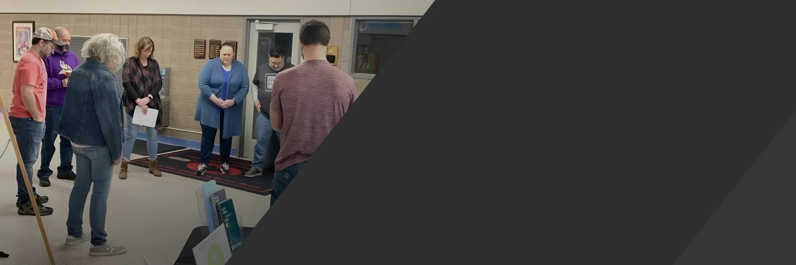 Clarity Church members praying together in a circle at Edinbrook Elementary in Brooklyn Park