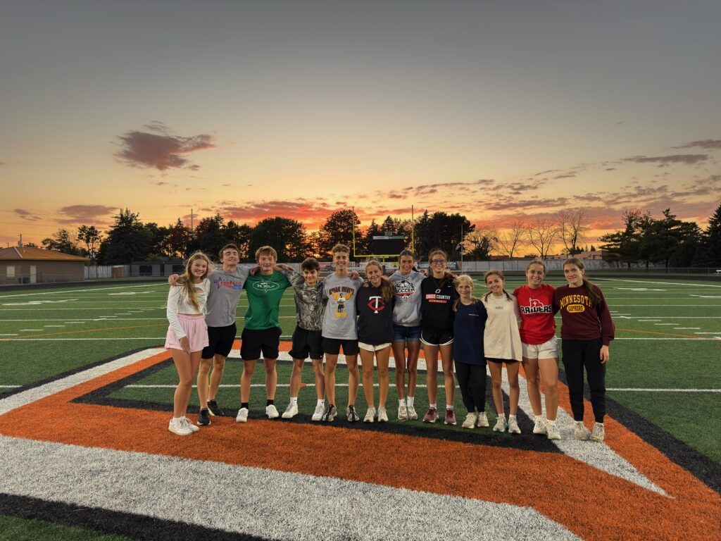 FCA students on the Osseo High School football field at sunset