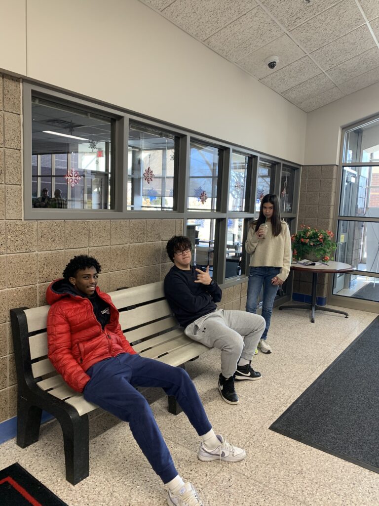 High school students hanging out together on a bench at a student ministry gathering
