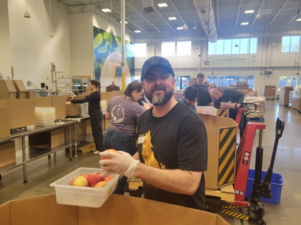 A Clarity Church volunteer packing fresh produce at Second Harvest Heartland